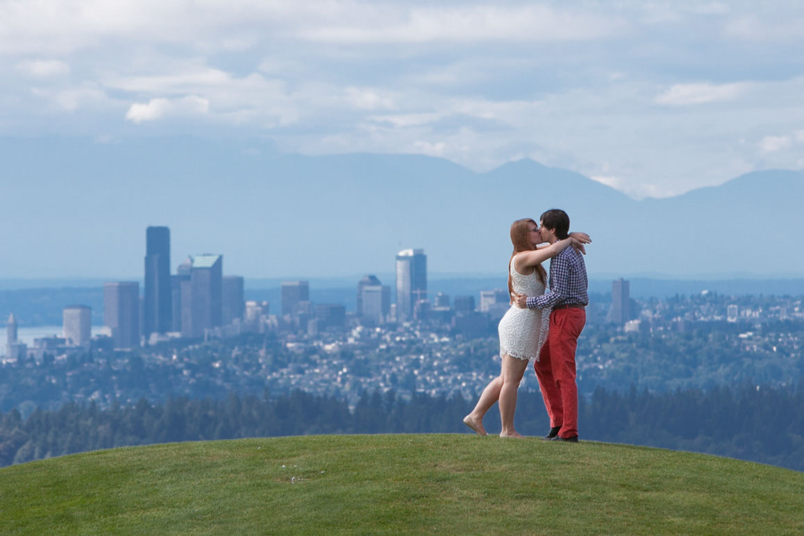 Engagement photo at Gasworks Park in Seattle Couple kissing on top of the Kite Hill during engagement photo session at Gasworks Park