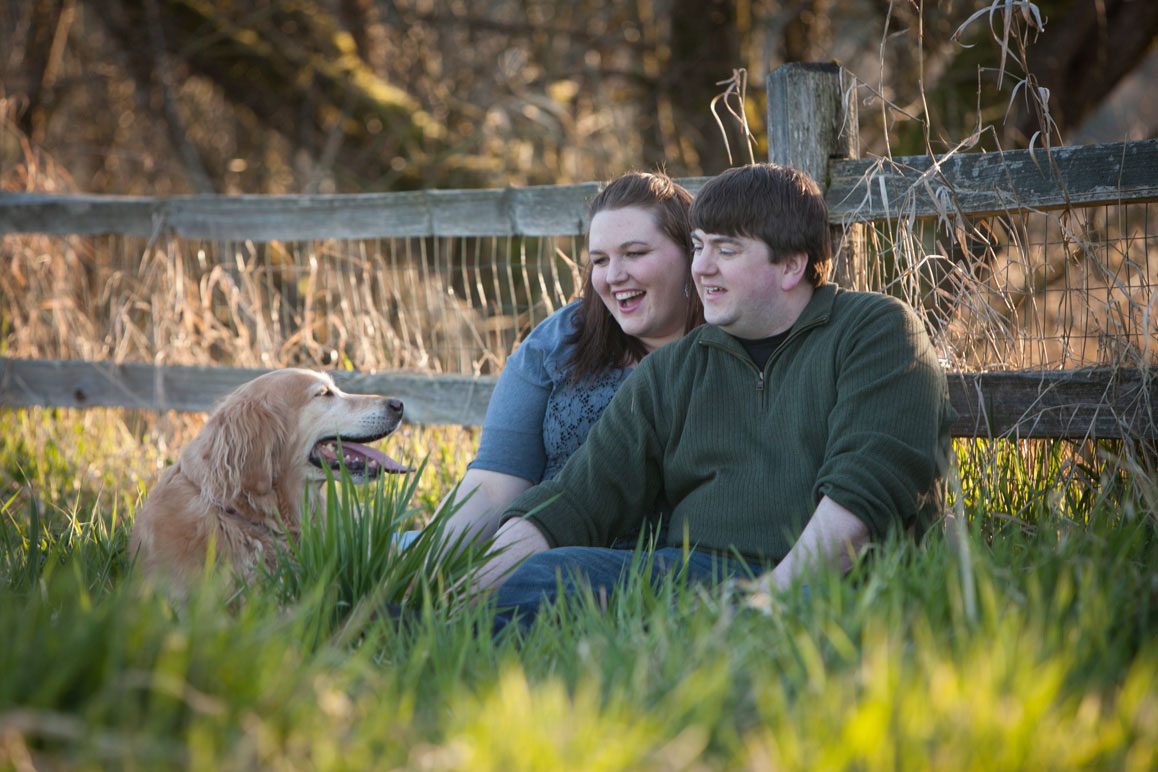Michele & Brian, engagement photo at Marymoor Park Engagement photo of couple with their Golden Retriever, sitting in the grass at Marymoor Park