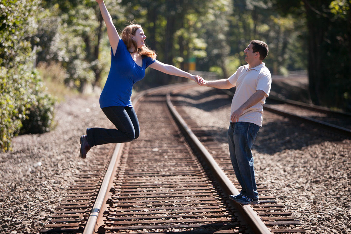 Engagement photo session at Golden Gardens Rachel & Brett having fun on the train tracks during their Seattle engagement photos at Golden Gardens