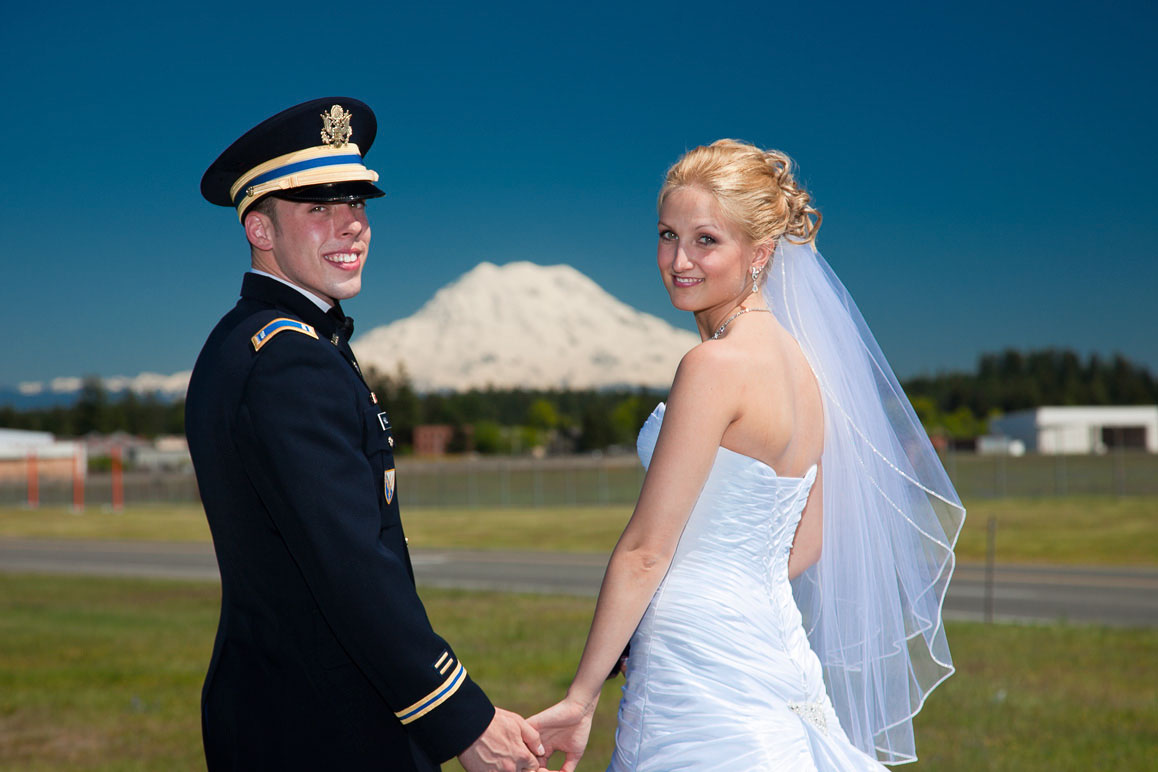 Kristine & Chris - Fort Lewis wedding Bride with groom in military dress uniform at Fort Lewis, Mt Rainier in the baqckground