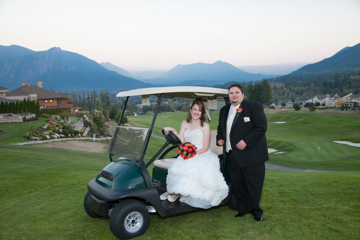 Shannon & Kaleb - Wedding at Snoqualmie Ridge Bride and groom with golf cart, Mt. Si in the background, at Snoqualmie Ridge