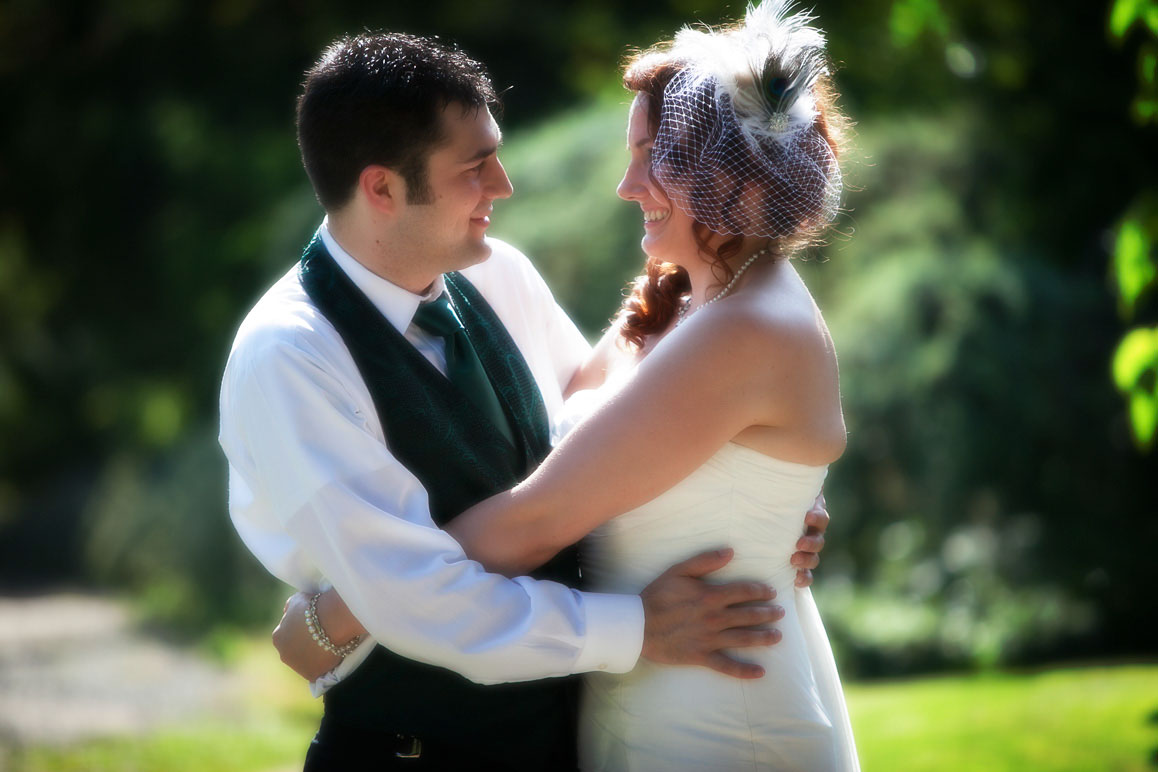 Lisa & Kelly - Seattle wedding at Kubota Gardens Backlit photo of bride and groom hugging at Kubota Garden in Seattle